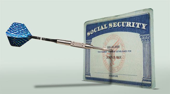 A photo shows a social security card with a dart sticking out of it
