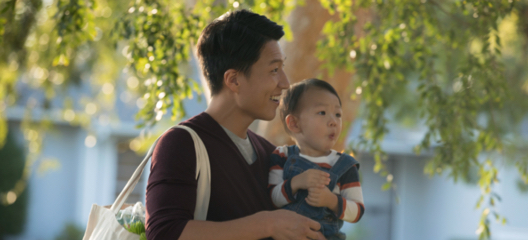 Asian man holding his son