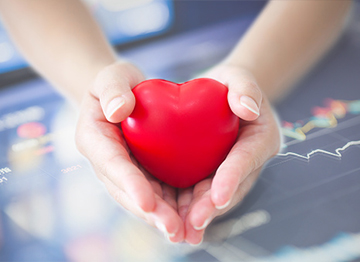 Article Image - Hands cupping a red heart. Learn about tax advantaged ways to help others.