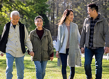Article Image - A multi-generational family walking together in a park. Read how to avoid inheritance mistakes.