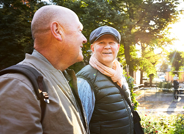 Article Image - Two men walking through a park talking. Read how to your income needs throughout retirement.