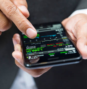 hands scrolling through a stock chart on a mobile phone